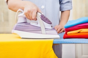 Cleaner Ironing Clothes On Ironing Board