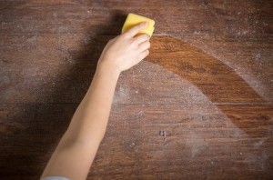 a cleaner wiping away builders dust