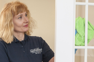 cleaner wiping a door for Domestic Cleaning London